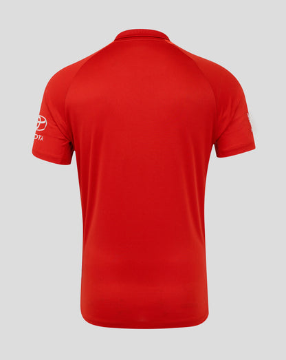 Red polo shirt with a brand logo on the sleeve against a gray background