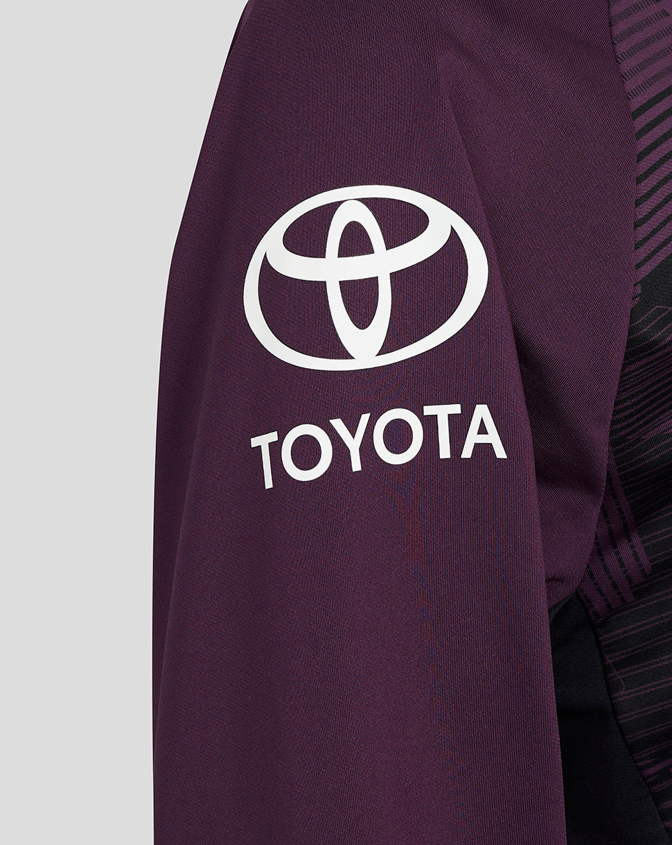 Close-up of a purple jacket with Toyota logo on a light gray background