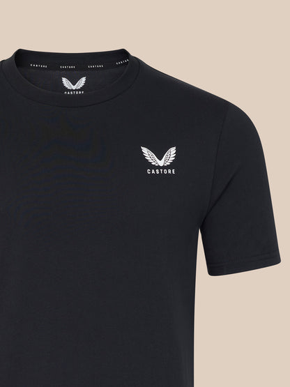 Black t-shirt with a white logo on a beige background