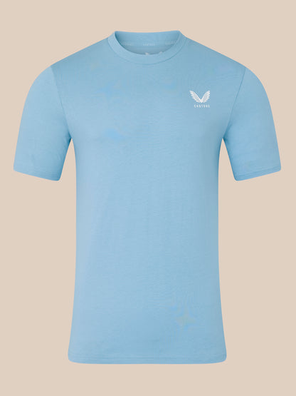 Light blue t-shirt with a logo on a beige background