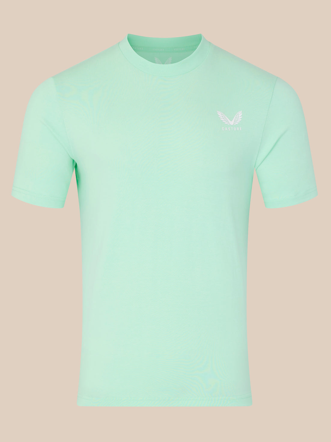 Mint green t-shirt with a small logo on a beige background