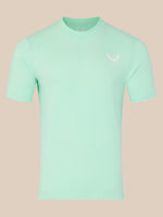Mint green t-shirt with a small logo on a beige background