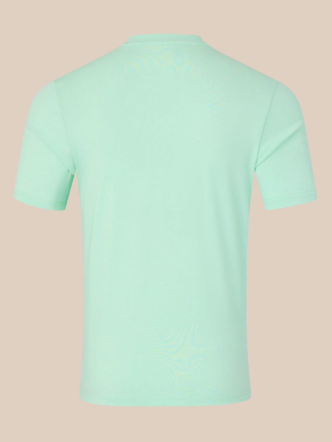 Mint green t-shirt on a beige background
