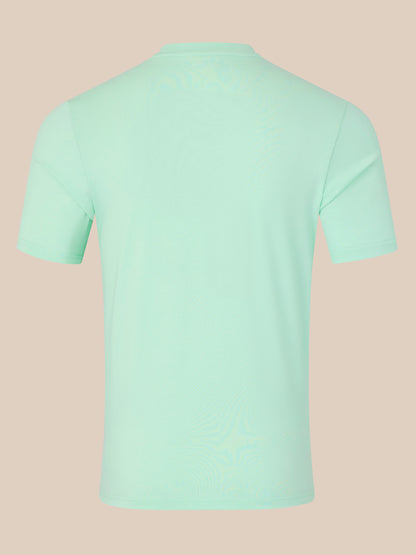 Mint green t-shirt on a beige background