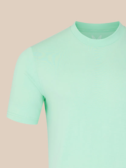 Light green t-shirt on a beige background
