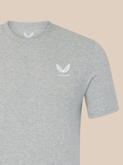 Gray t-shirt with a white logo on a beige background