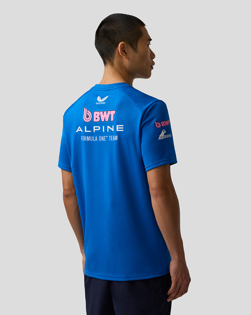 Person wearing a blue t-shirt with BWT Alpine Formula One Team logos on the back, standing against a plain background.