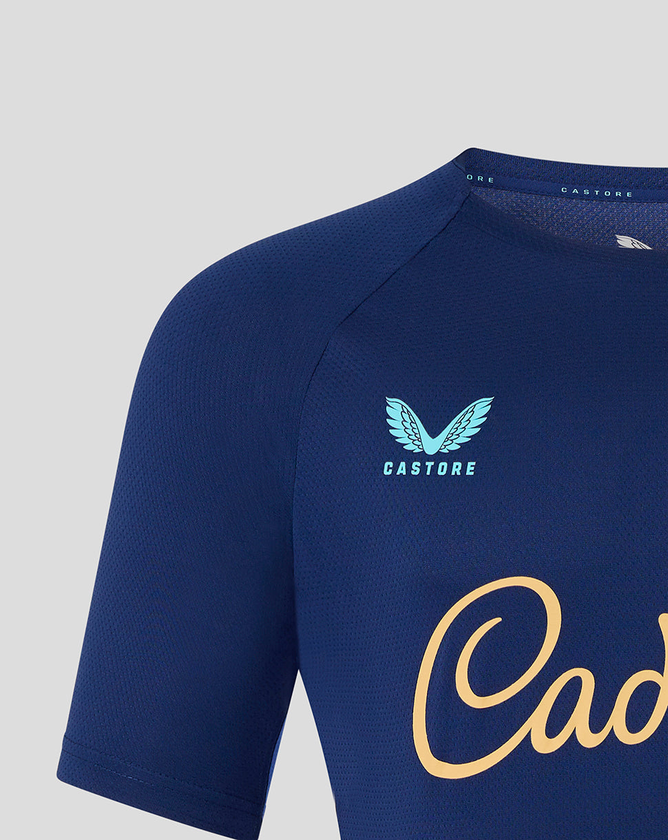 Blue athletic shirt with 'Castore' branding on a gray background