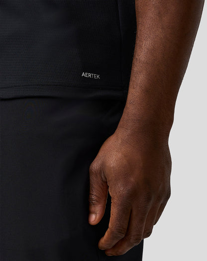 Close-up of a person wearing a black garment with 'AERTEK' branding.