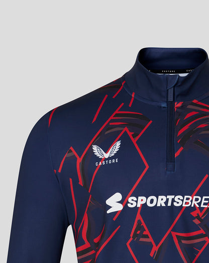 Navy sports jacket with red patterns and visible branding on a gray background