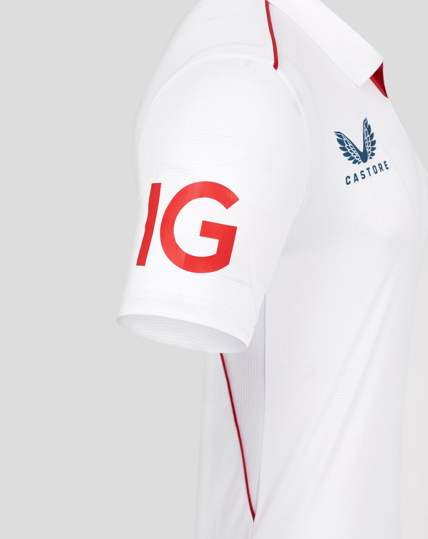 White sports jersey with red and blue branding on a light gray background