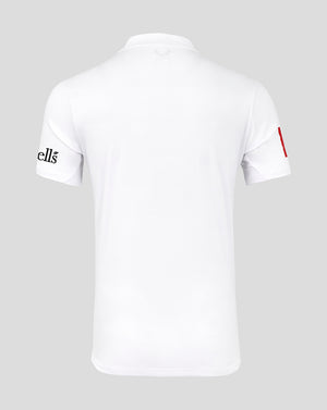 White t-shirt with brand logo on sleeve against a gray background