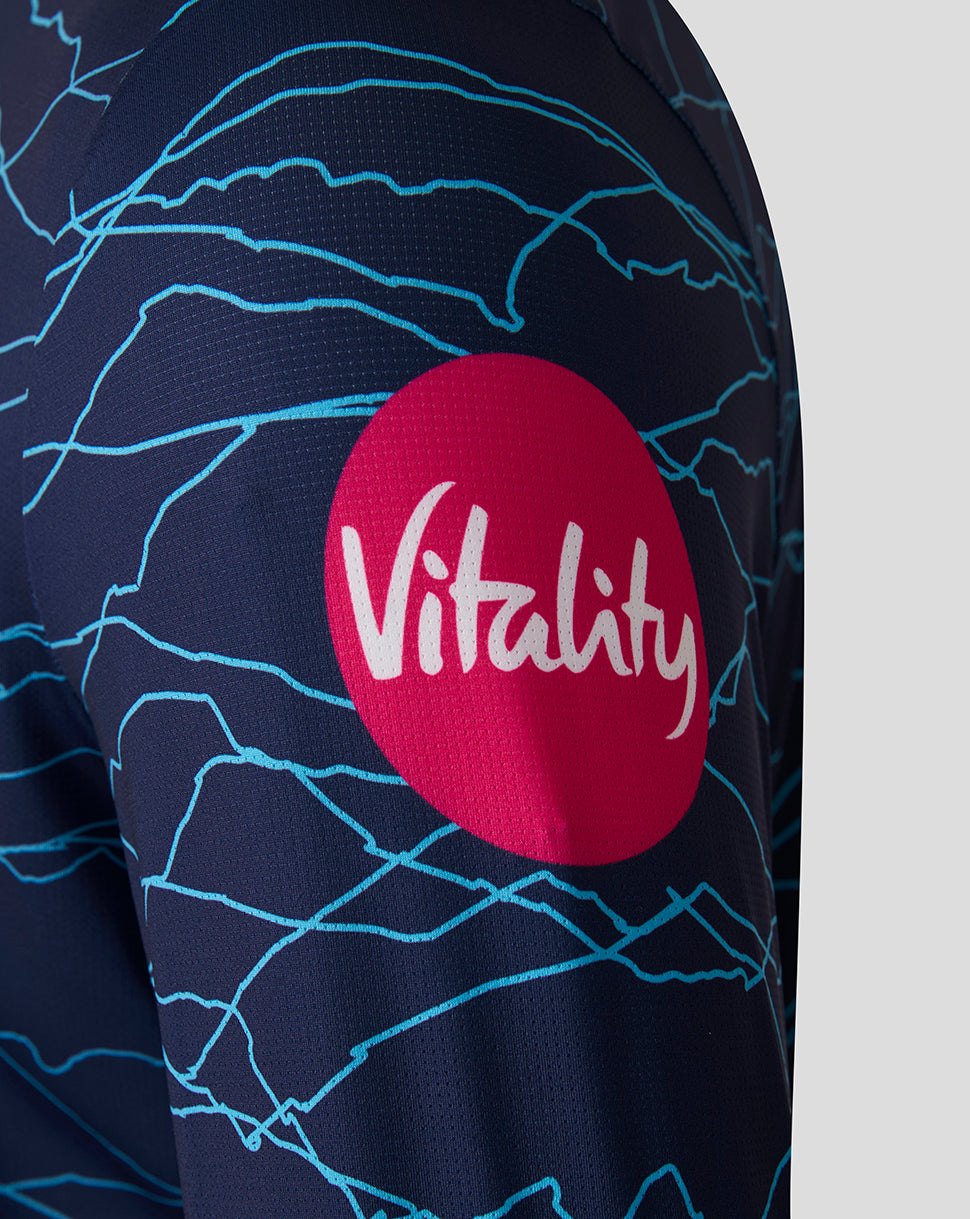 Navy blue sports jersey with blue patterns and a red circle featuring the word 'Vitality' on a gray background