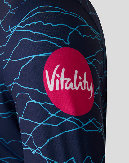 Navy blue sports jersey with blue patterns and a red circle featuring the word 'Vitality' on a gray background