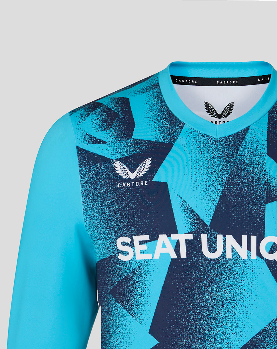 Blue sports jersey with geometric pattern and visible branding on a light gray background