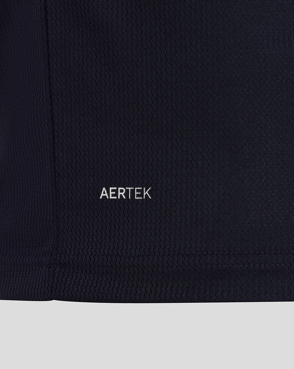 Close-up of a black garment with 'AERTEK' branding on a dark background