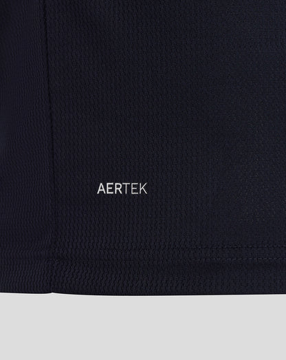 Close-up of a black garment with 'AERTEK' branding on a dark background