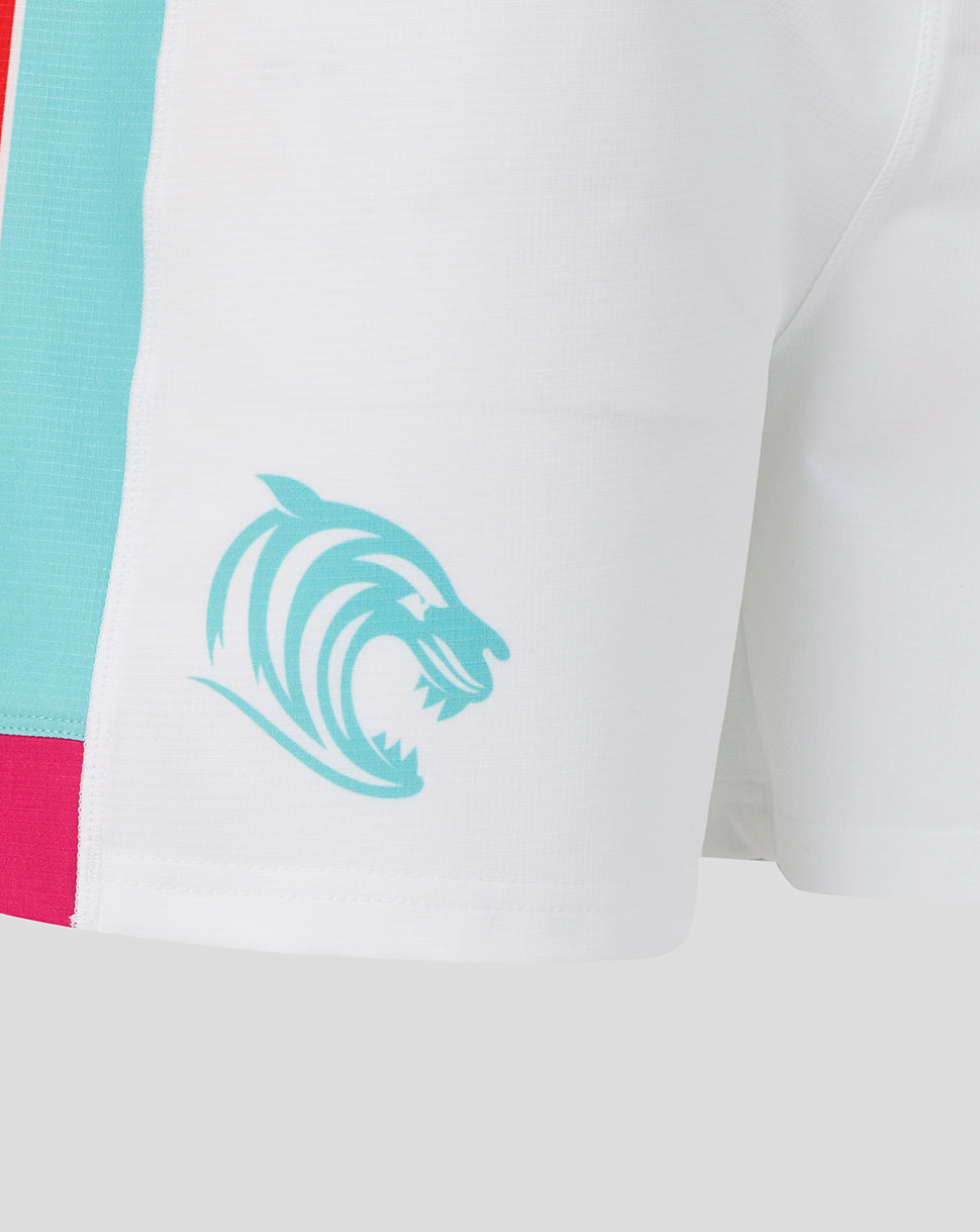 Close-up of a sports jersey with a logo and color-block design.