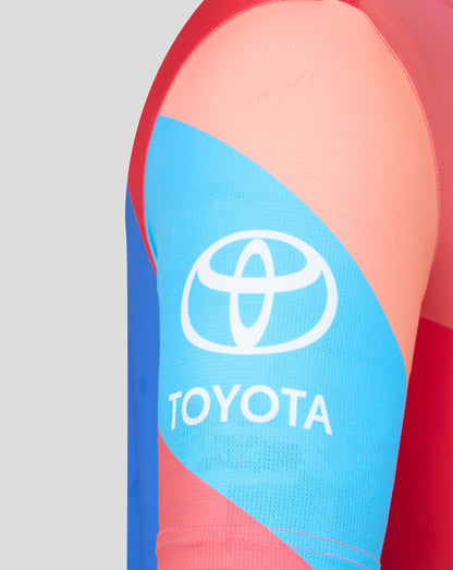 Close-up of a sports sleeve with Toyota logo on a red and blue background