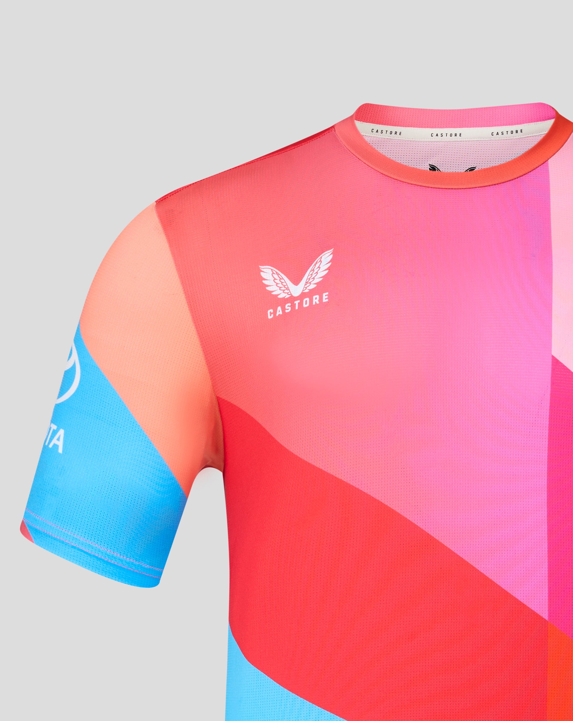 Colorful athletic shirt with a brand logo on a gray background