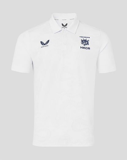 White polo shirt with embroidered logos on a light gray background