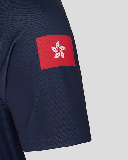 Navy blue shirt with a red and white emblem on the sleeve against a light gray background