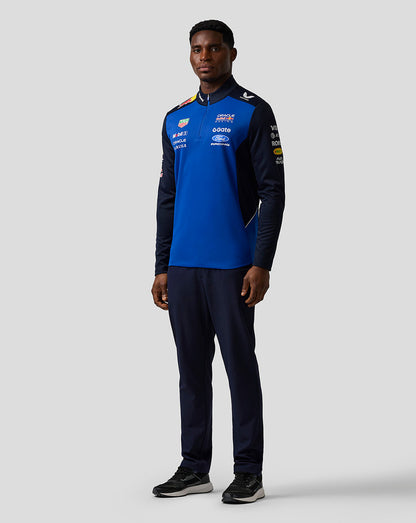 Person wearing a blue and black sports outfit with visible branding on a white background