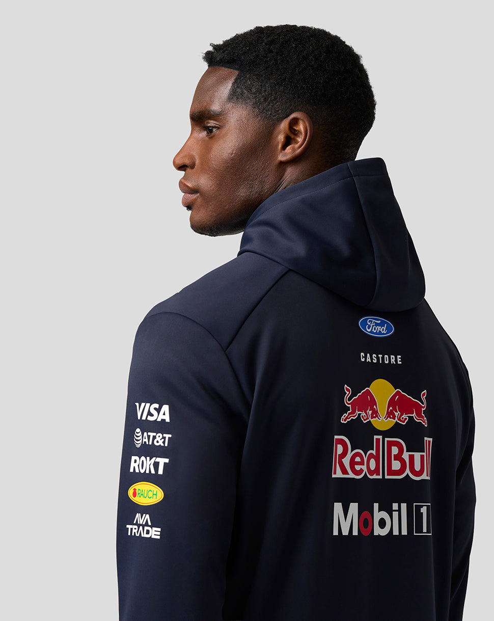 Person wearing a navy hoodie with Red Bull and Ford logos on a gray background