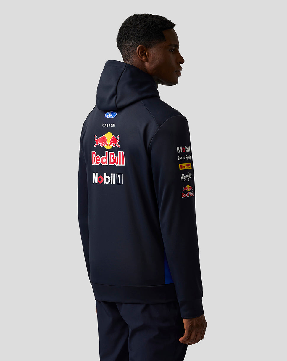 Person wearing a navy hoodie with Red Bull and Mobil 1 logos on the back against a white background