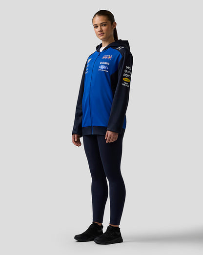 Person wearing a blue and black jacket with visible branding on a white background