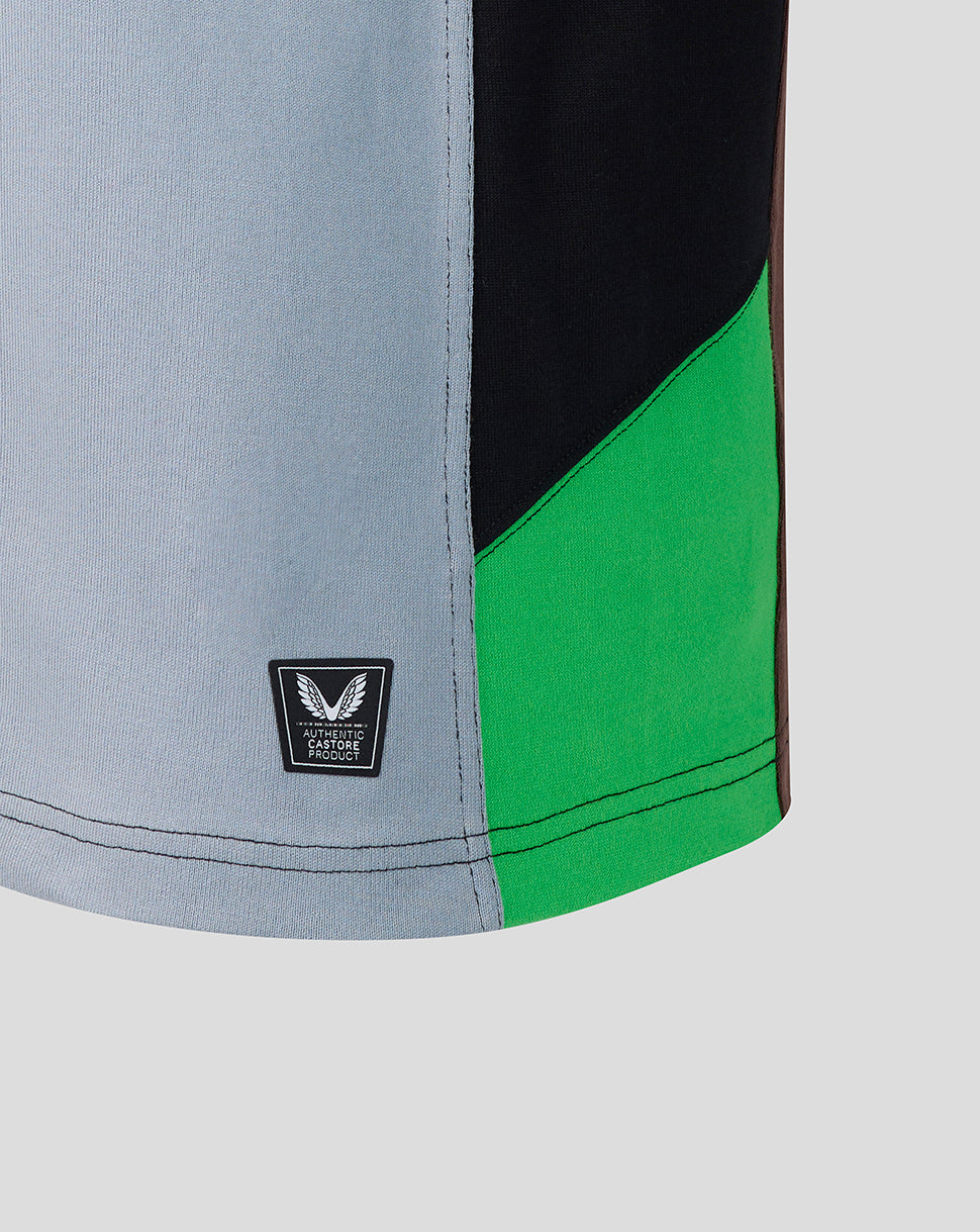 Close-up of a sports shorts with gray, black, and green color block design on a light gray background.