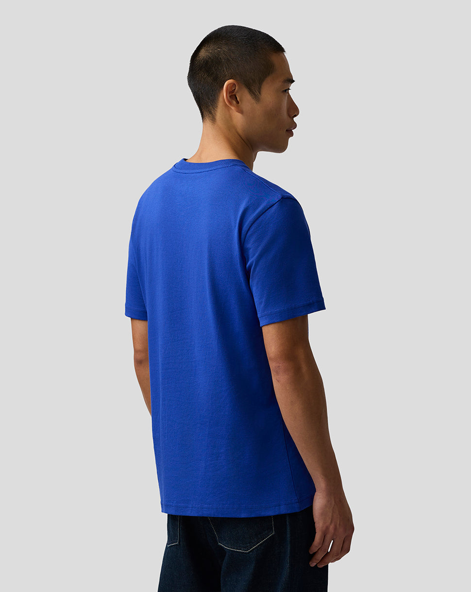 Person wearing a blue t-shirt on a plain background