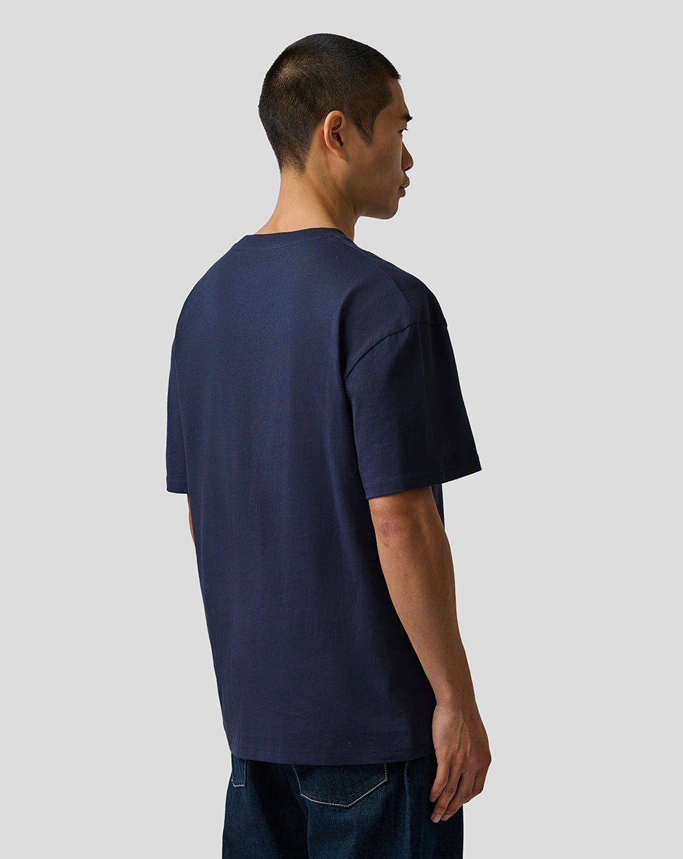 Man wearing a navy blue t-shirt against a plain background