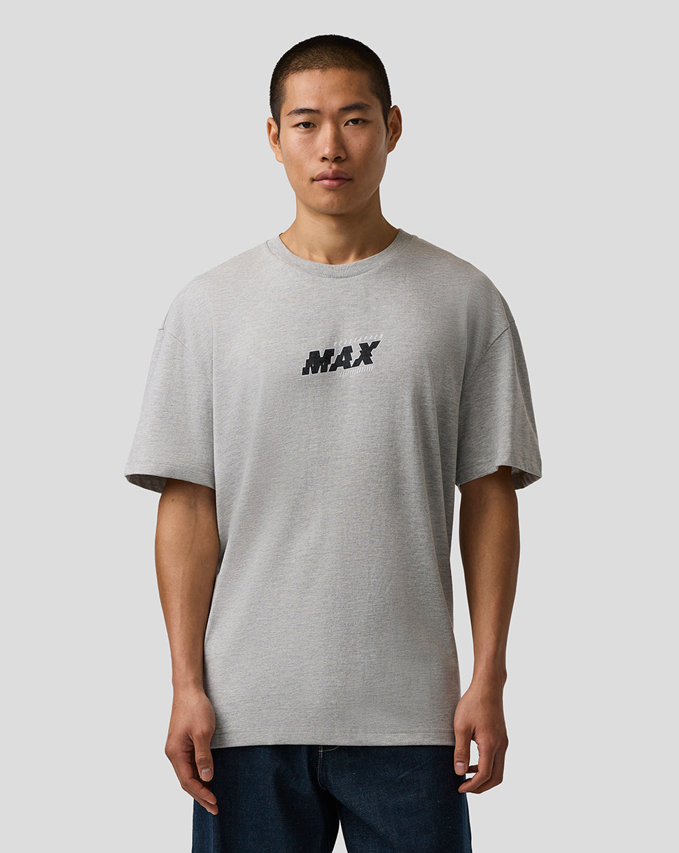 Man wearing a gray t-shirt with 'MAX' print on a plain background