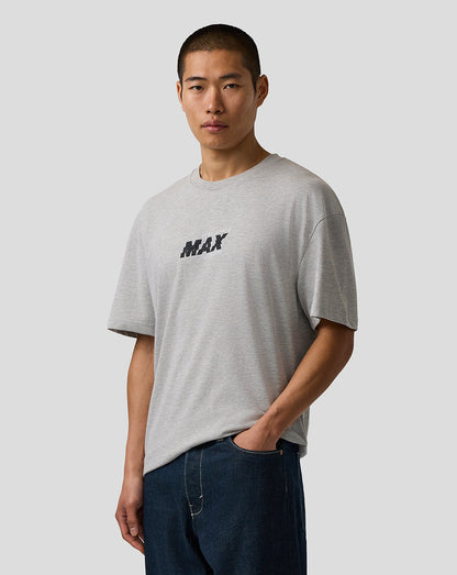 Man wearing a gray t-shirt with 'MAX' logo on a plain background