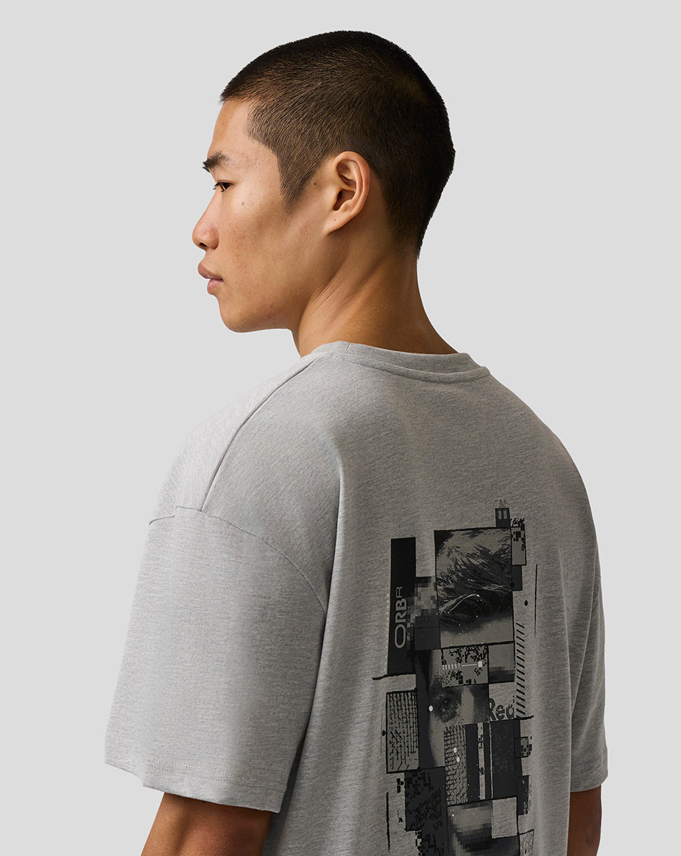 Person wearing a gray t-shirt with a graphic design on the back against a light gray background