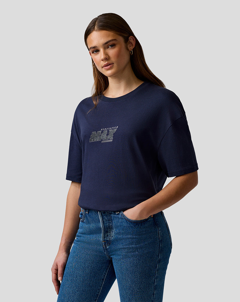 Woman wearing a navy blue t-shirt with a logo and blue jeans on a light gray background