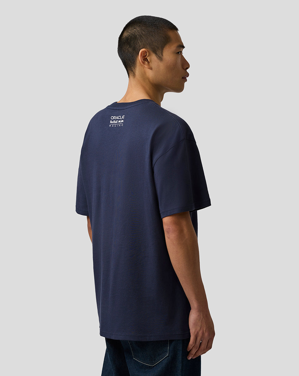 Man wearing a navy blue t-shirt with text on the back against a plain background
