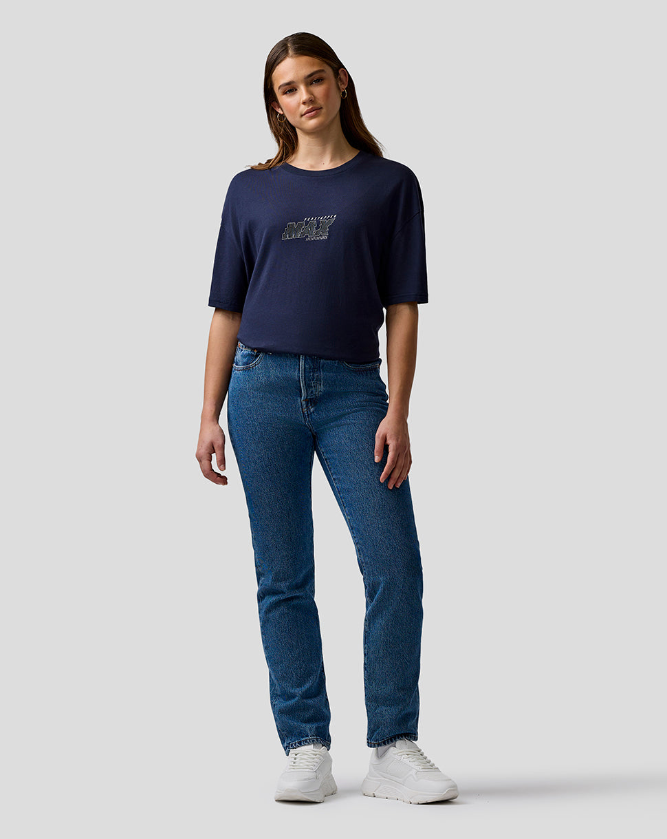 Woman wearing a navy t-shirt and blue jeans on a white background