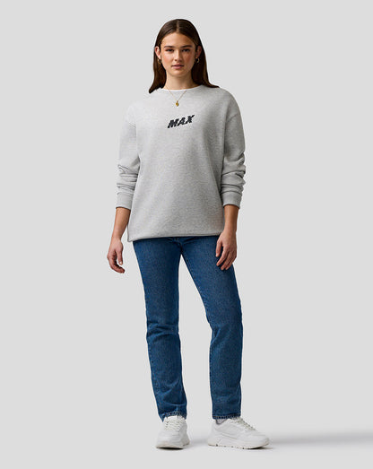 Person wearing a gray sweatshirt with 'MAX' text and blue jeans on a white background