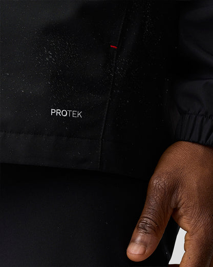 Black jacket with 'PROTEK' branding on a dark background