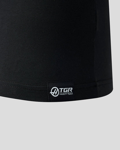 Black t-shirt with a visible brand logo on a light gray background