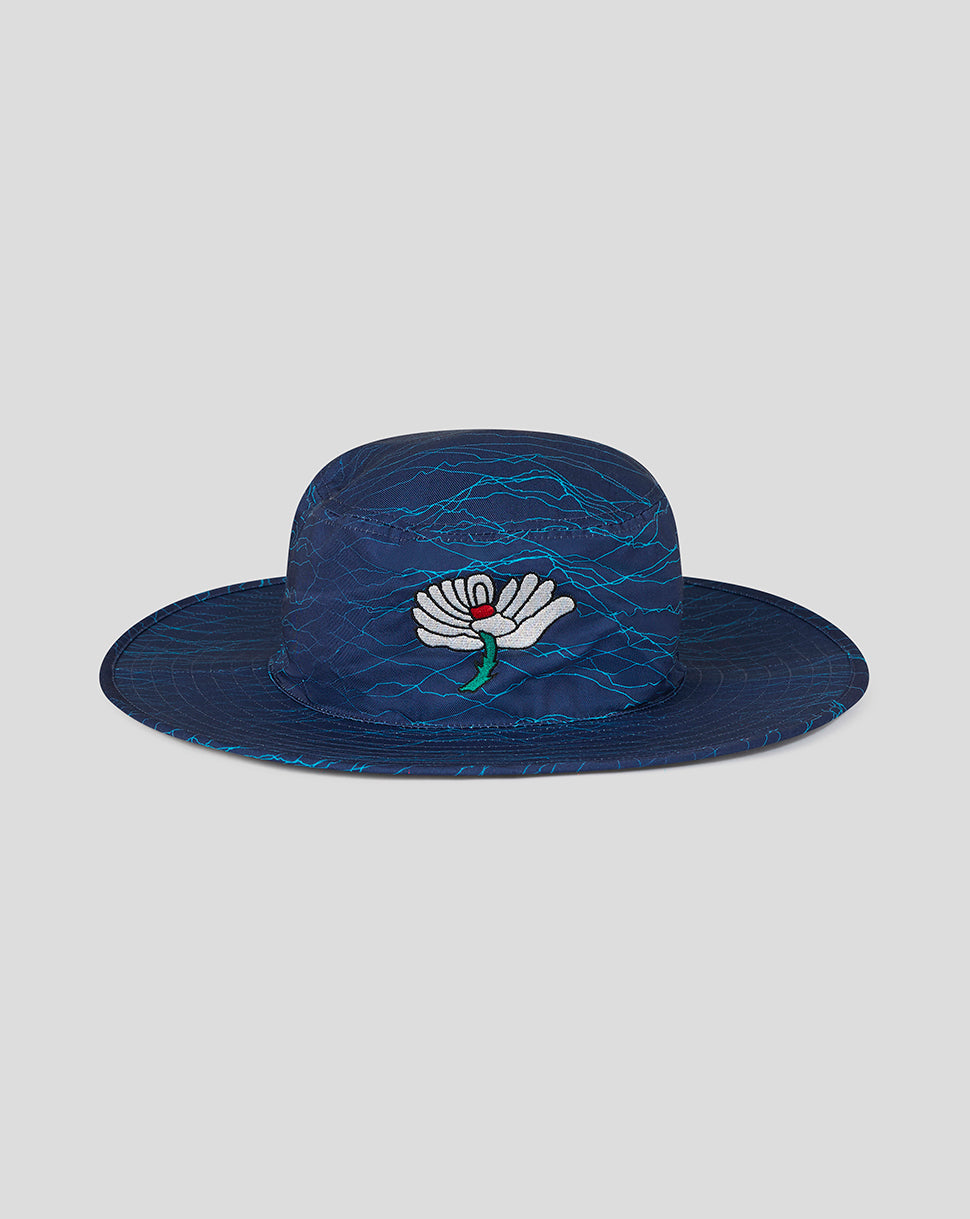 Blue woven hat with a floral design on a light gray background