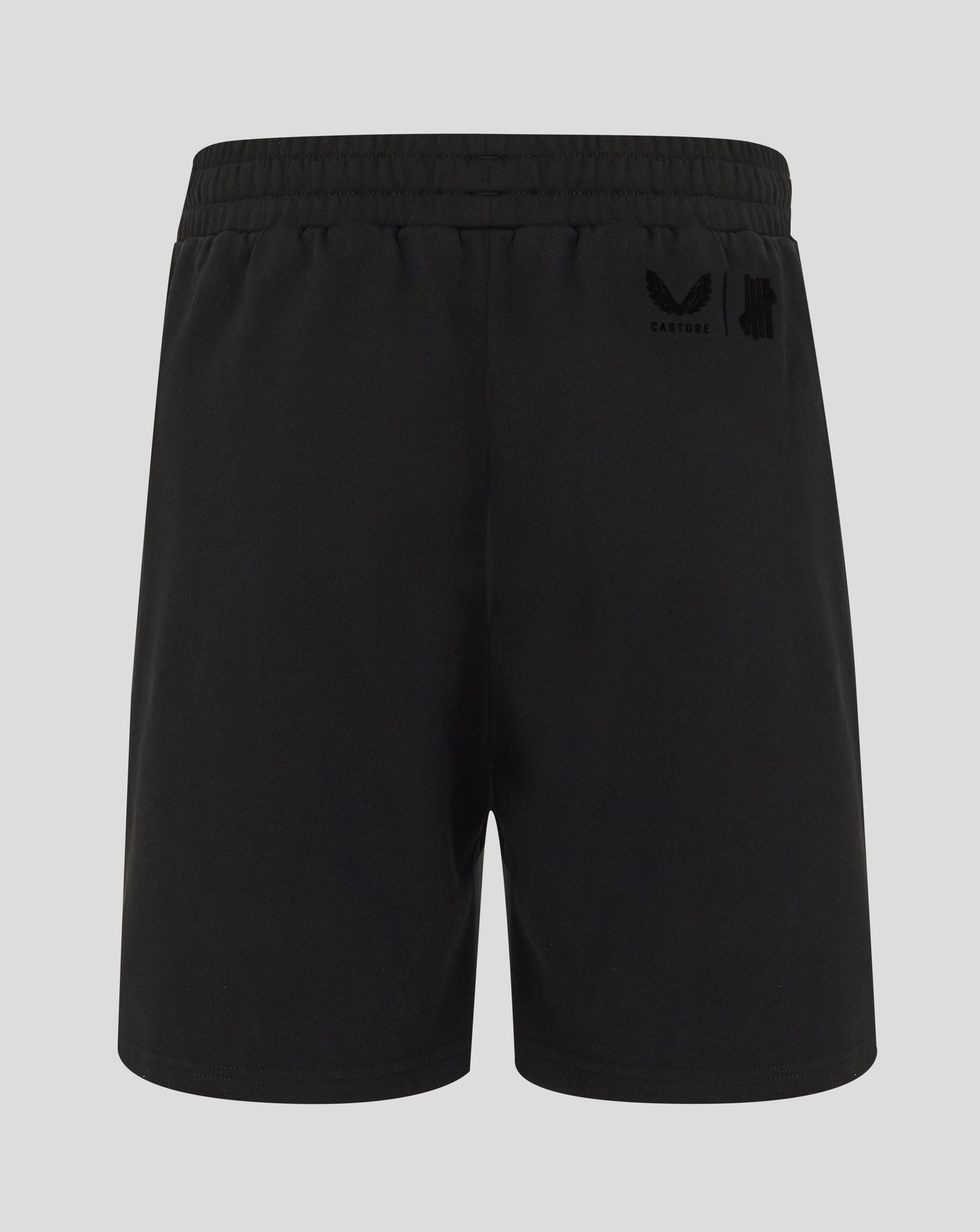 Black shorts with a logo on the back pocket against a light gray background