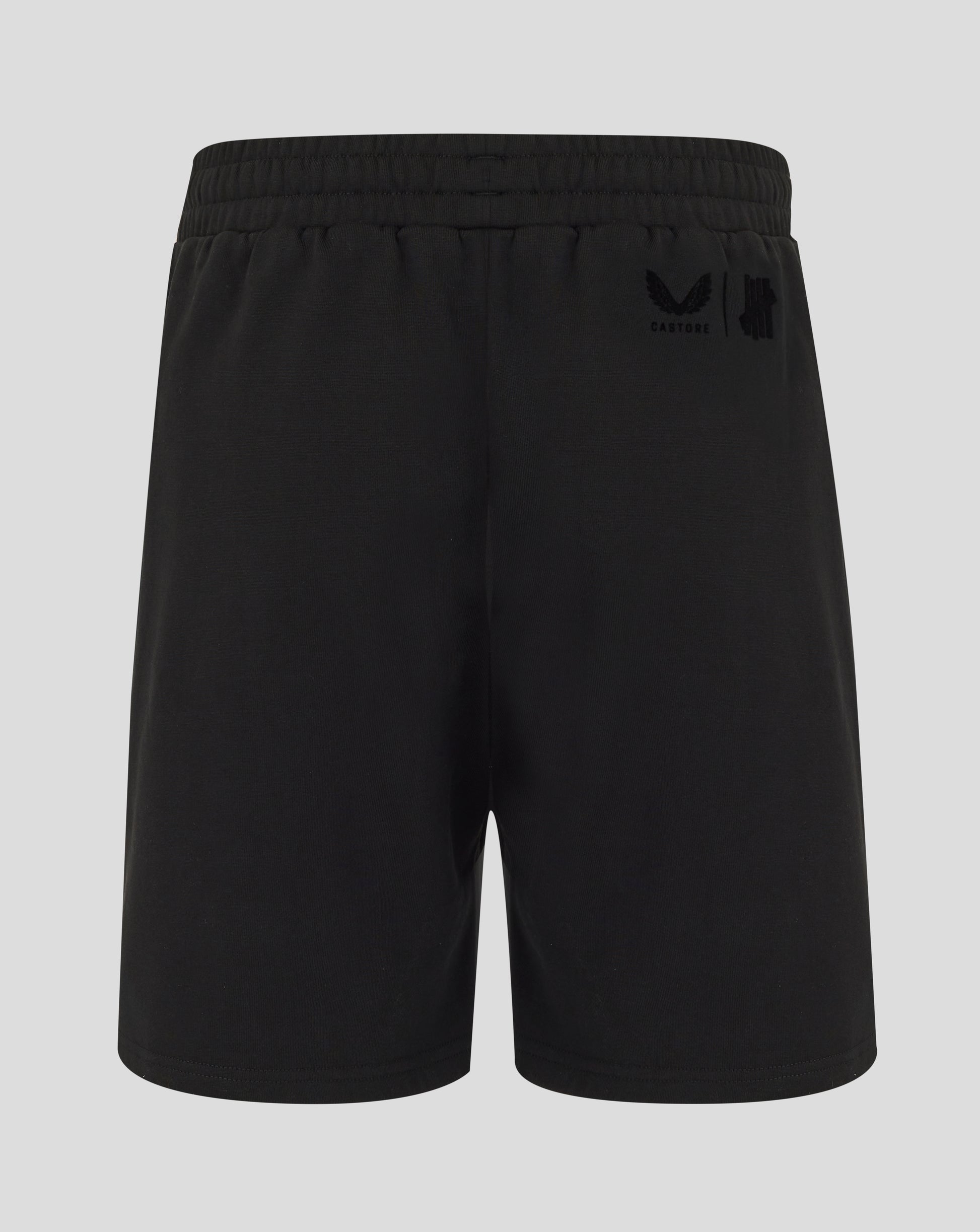 Black shorts with a logo on the back pocket against a light gray background