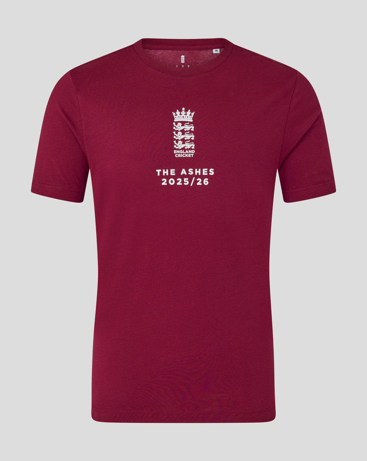 Burgundy England cricket T shirt close up with white crest and The Ashes 2025/26 text on front.