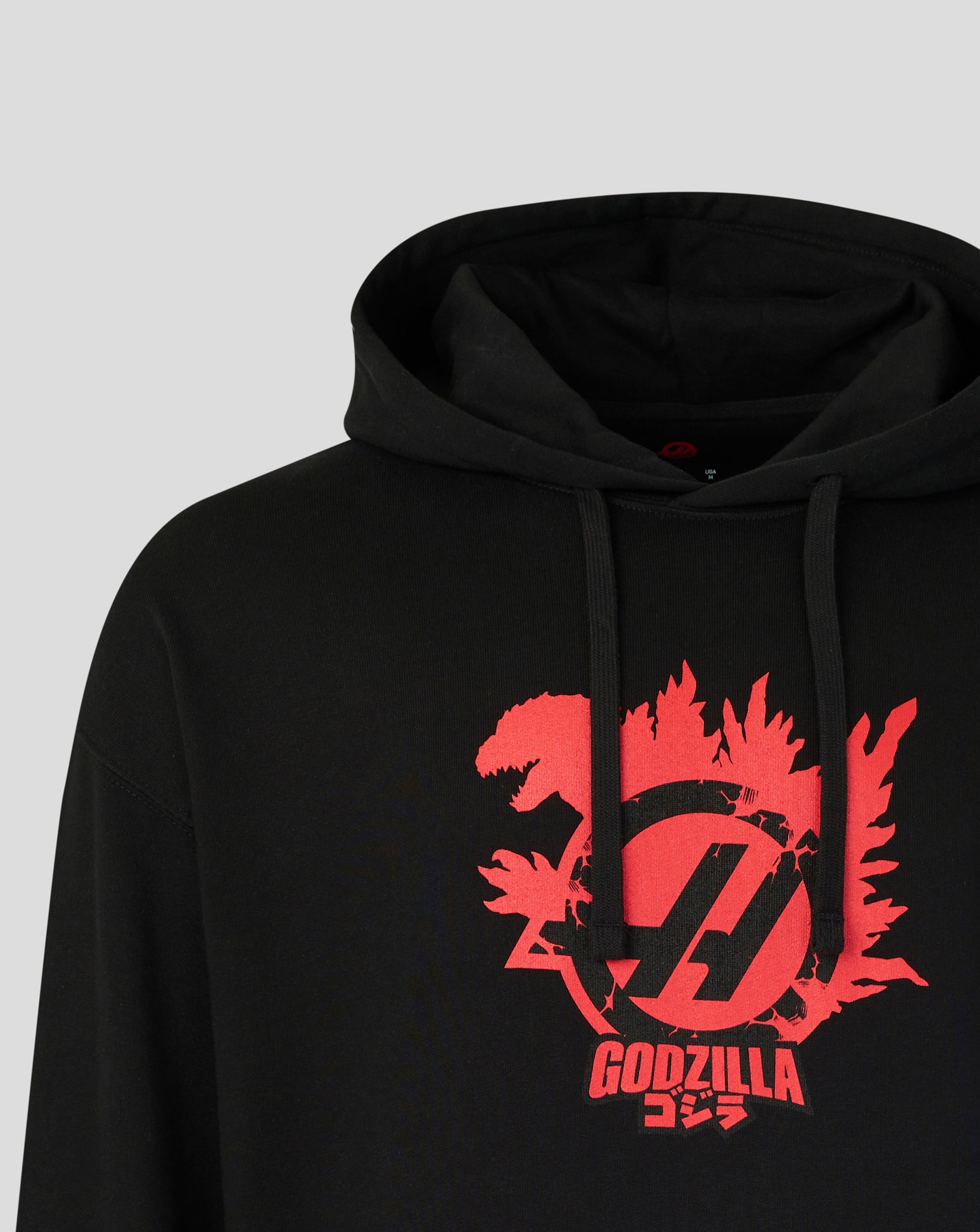 Black hoodie with red Godzilla logo on a gray background