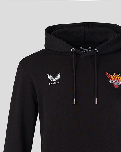 Close up of black hoodie showing Castore wing logo on left chest and colorful Sunrisers crest on right chest