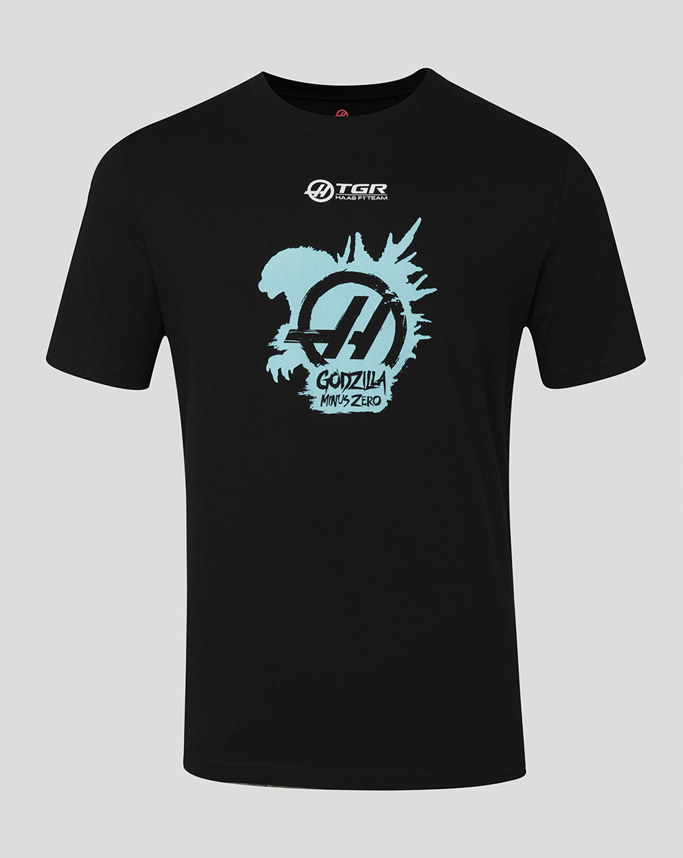 A black short-sleeve crewneck t-shirt featuring a light blue Godzilla Minus One graphic on the chest, with a white TGR logo printed above it, shown against a solid gray background.