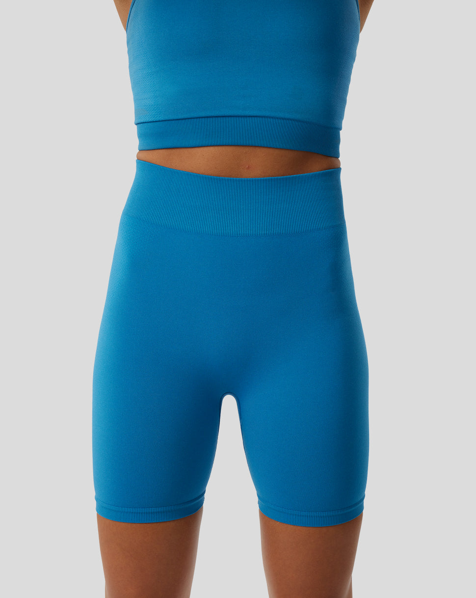 Back view of blue high waist seamless gym shorts on a model.